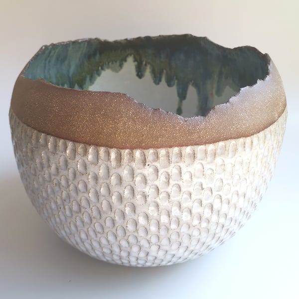 Large coiled and hand carved bowl