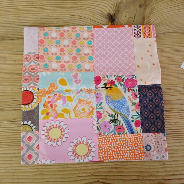 Cushion cover in a peach abstract theme and envelope closure.
