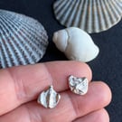 Mismatch pair of recycled silver stud earrings.