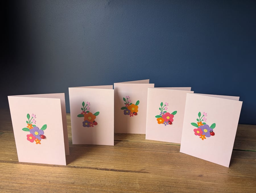 Five blank pink cards with handmade floral design with ladybird inc. envelopes