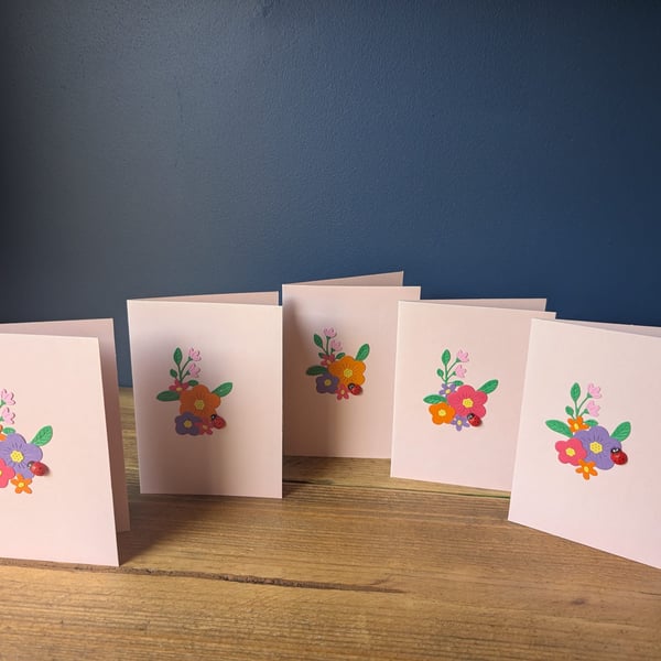 Five blank pink cards with handmade floral design with ladybird inc. envelopes