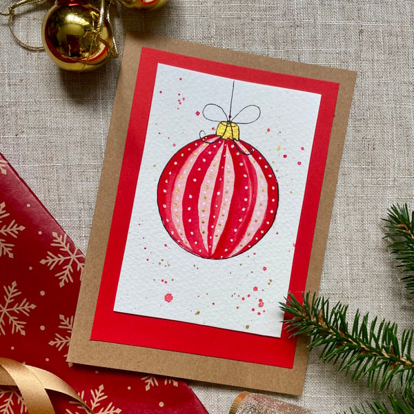Christmas card, hand painted original of a single christmas bauble in red.