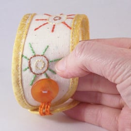 Hand embroidered textile jewellery for the wrist -  cuff in yellow and cream