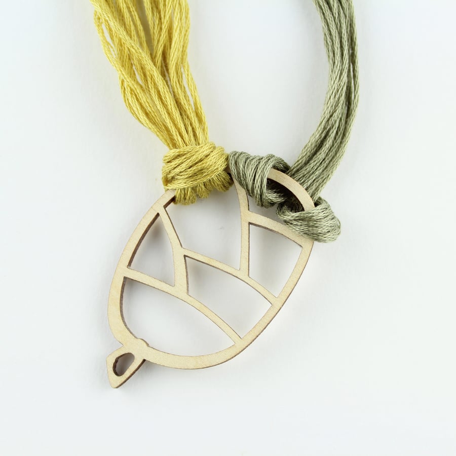 Pine cone thread holder and magnetic needle minder