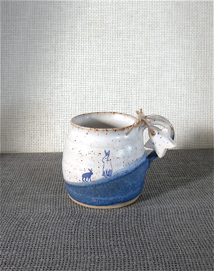 Rustic ceramic mug with hares in white and blue - handmade pottery