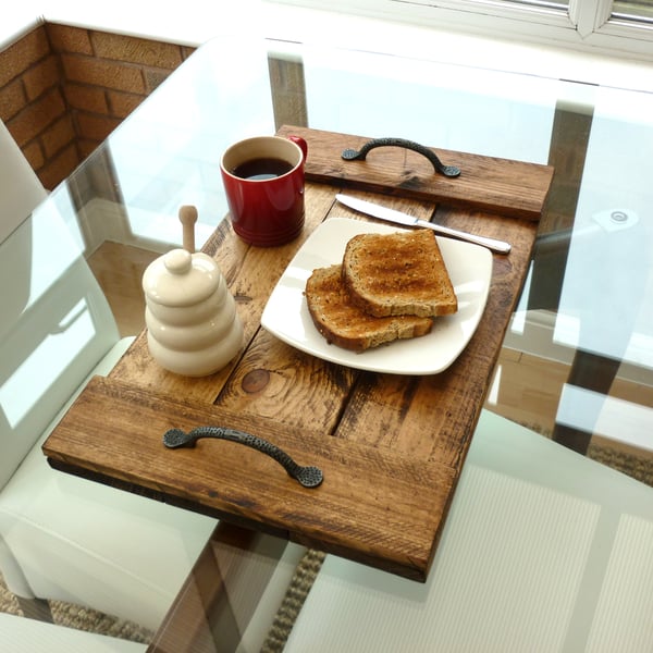 Rustic wooden serving tray with cast iron handles.