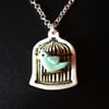 Bird in a cage ceramic pendant