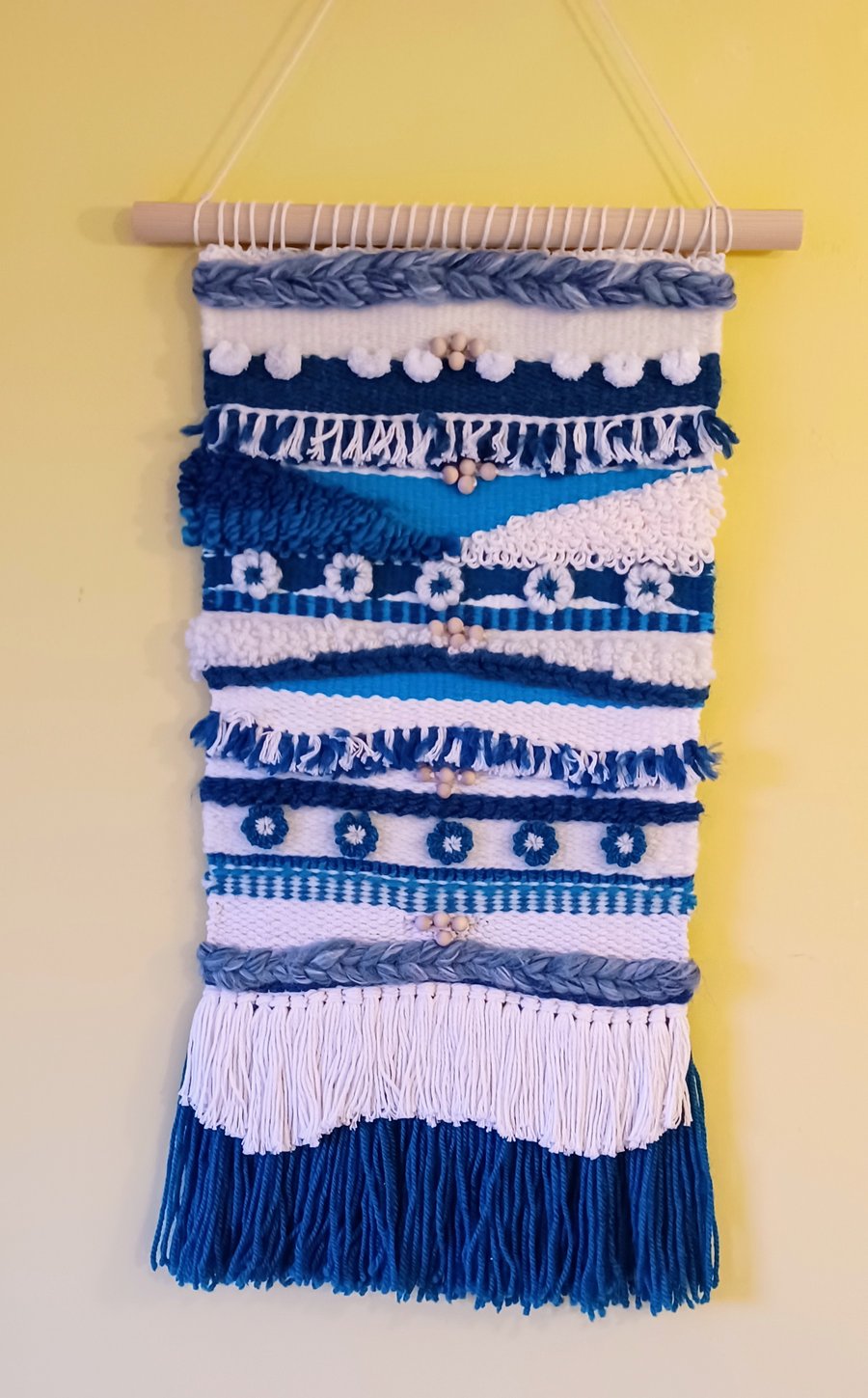 Woven wall hanging with abstract beads and flowers, blue and cream