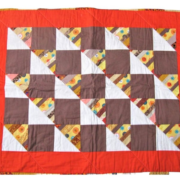 Lap quilt for winter warmth in bright oranges with brown and white.