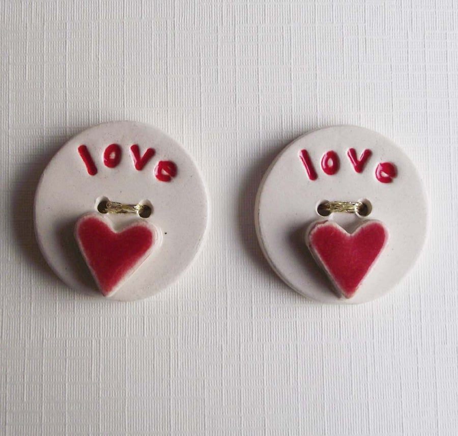 Set of two large ceramic buttons with the word LOVE on the front