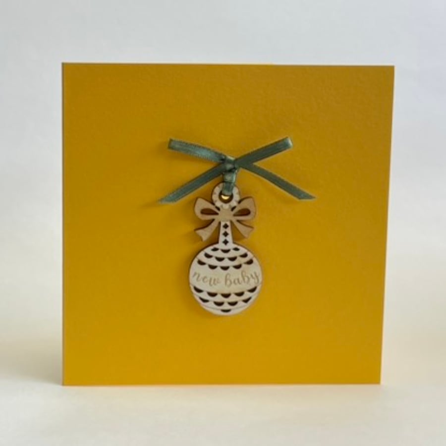 'New baby' rattle card with detachable decoration