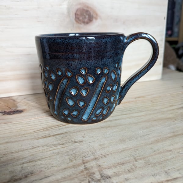 Dark carved mug