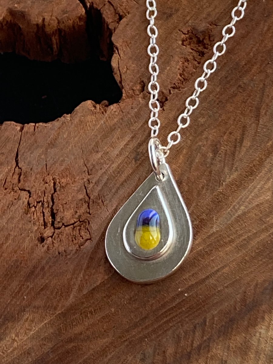 Layered teardrop pendant with blue and yellow glass detail