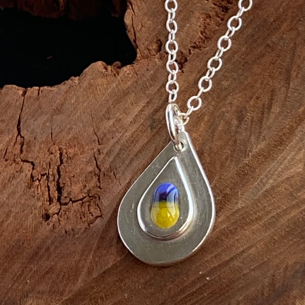 Layered teardrop pendant with blue and yellow glass detail