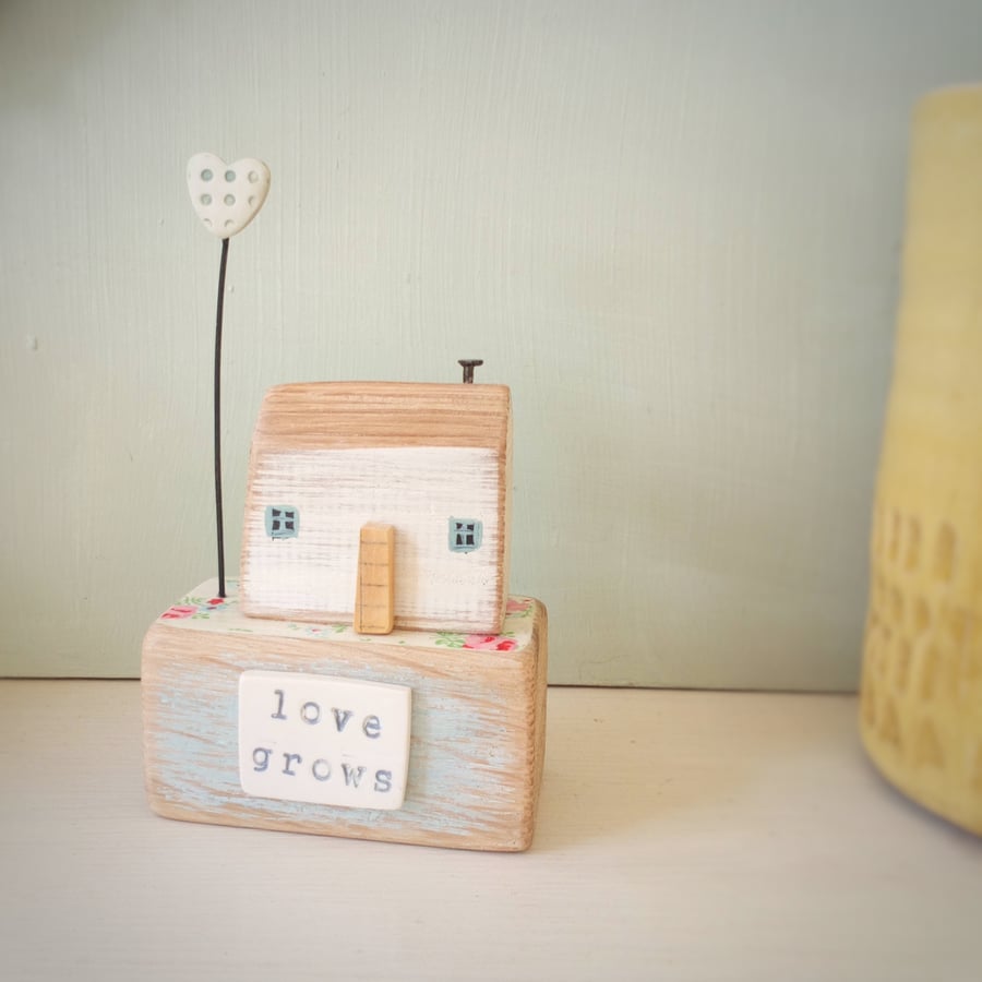 Wooden house with clay love heart garden 'love grows' 