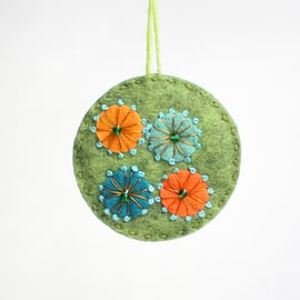 Circular felt hanging decoration with hand embroidery