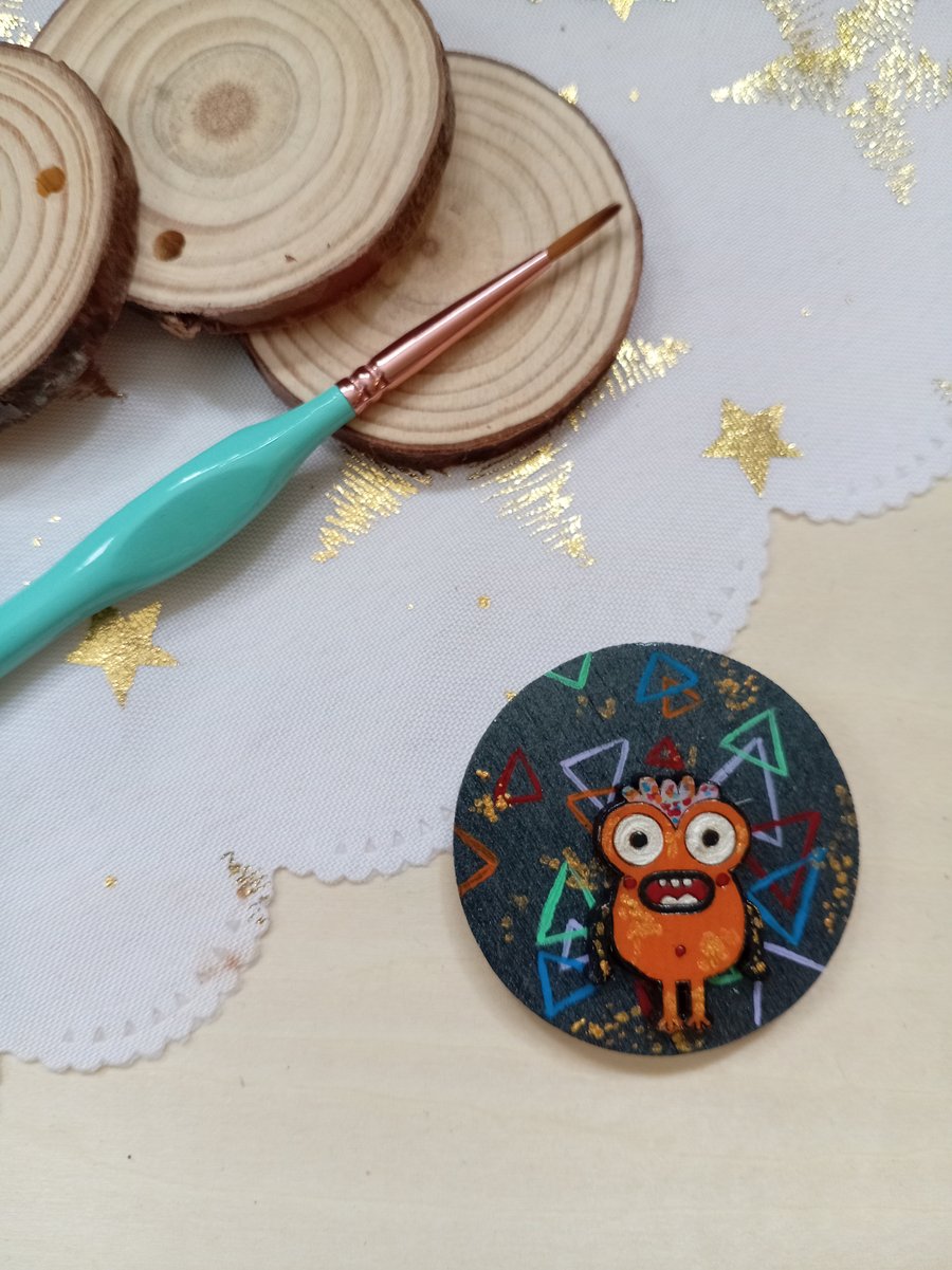 Wooden circular orange monster fridge magnet 