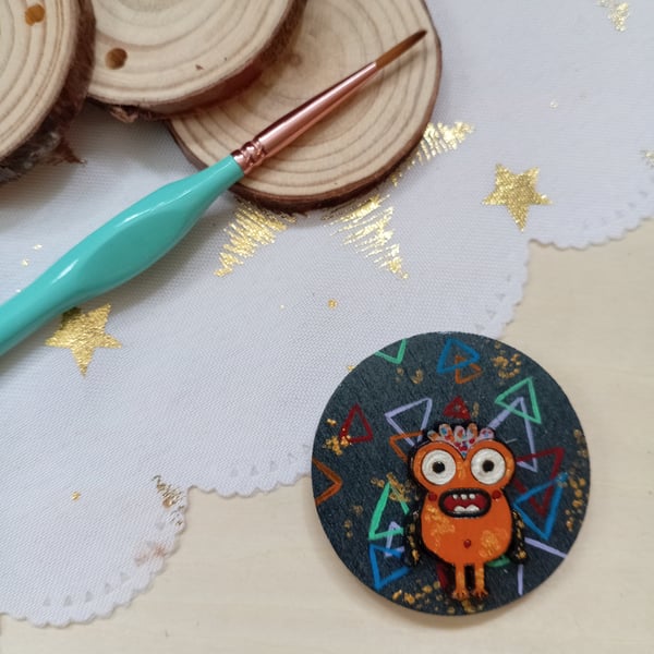 Wooden circular orange monster fridge magnet 