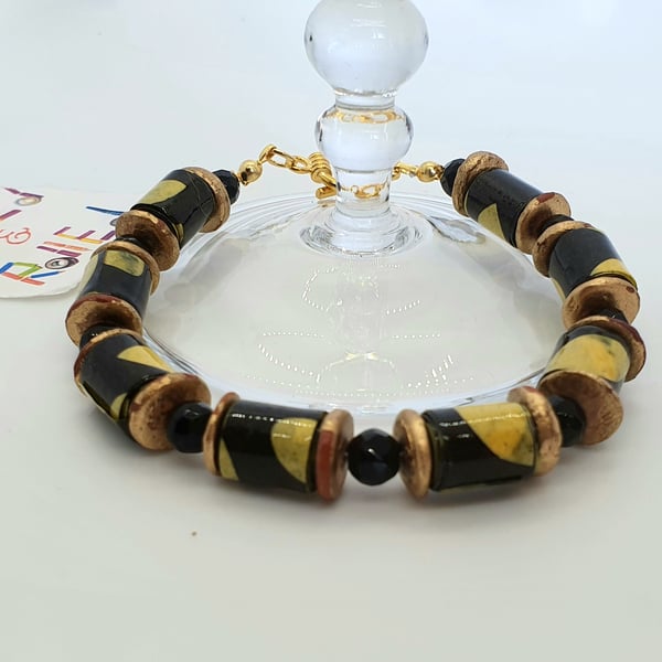 Black and yellow paper beaded bracelet with distressed bronze red spacers