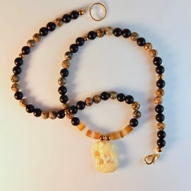 Carved Bone Elephant Pendant With Leopardskin Jasper, Black Onyx And Shell.