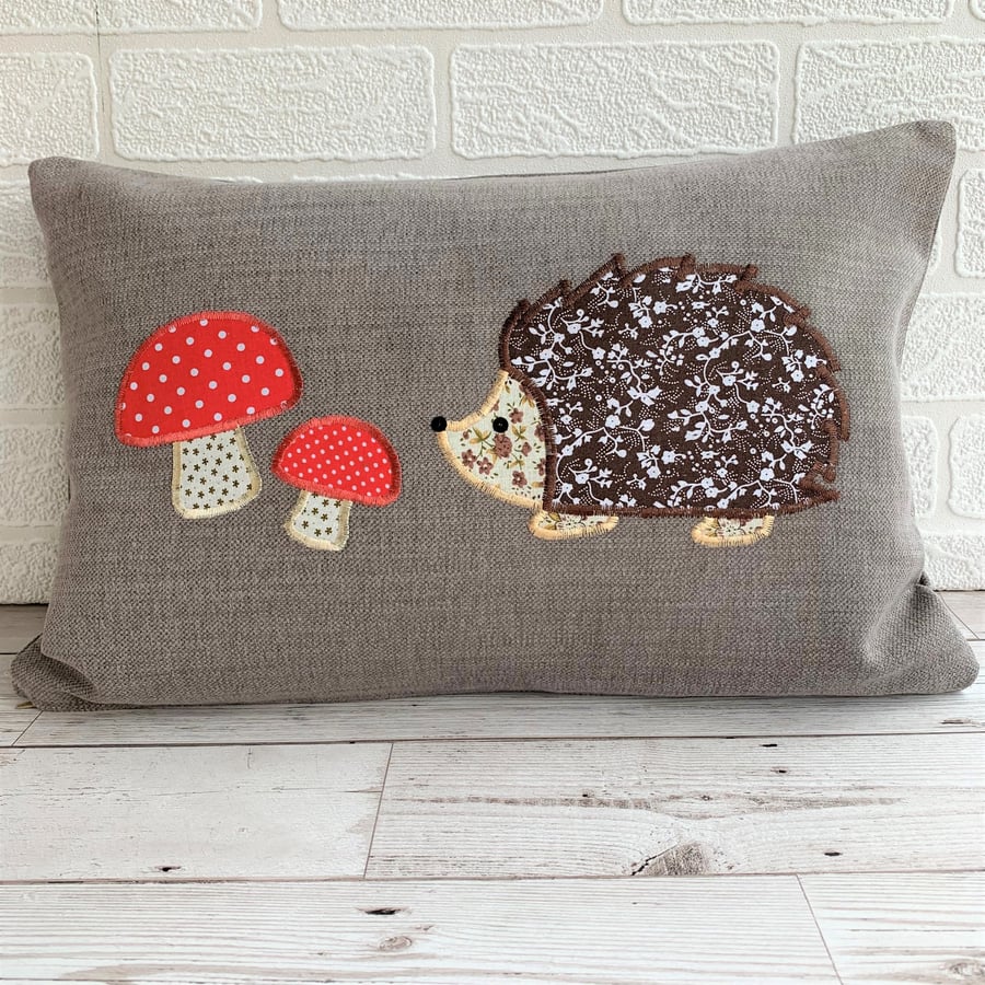 Hedgehog cushion with brown floral hedgehog and red polka dot toadstools