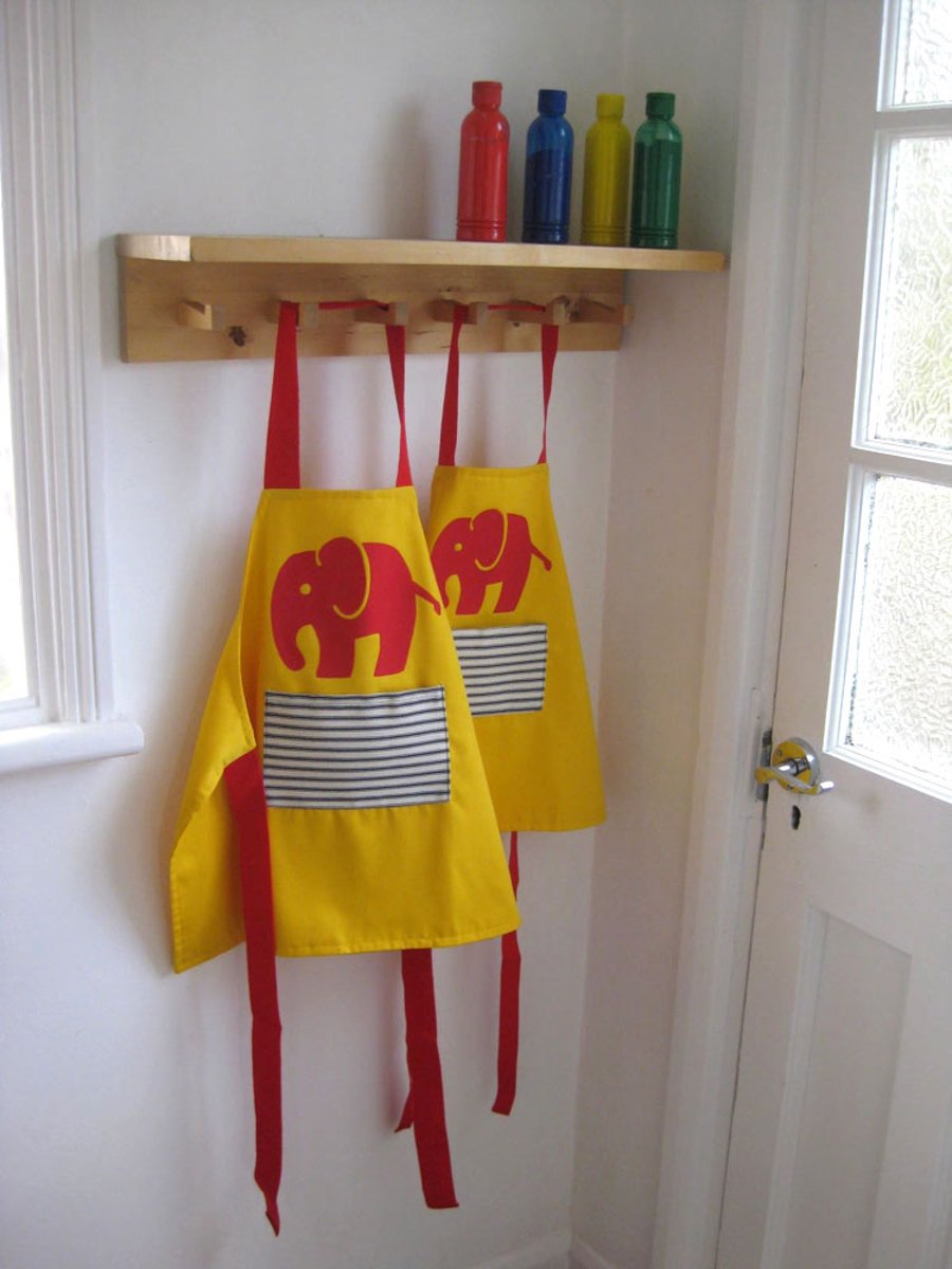 Age 1-2 yrs. Red 'Efalant' hand appliquéd child's yellow apron