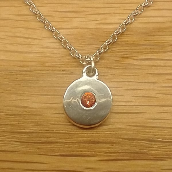 Round Silver pendant with light garnet colour cubic zirconia