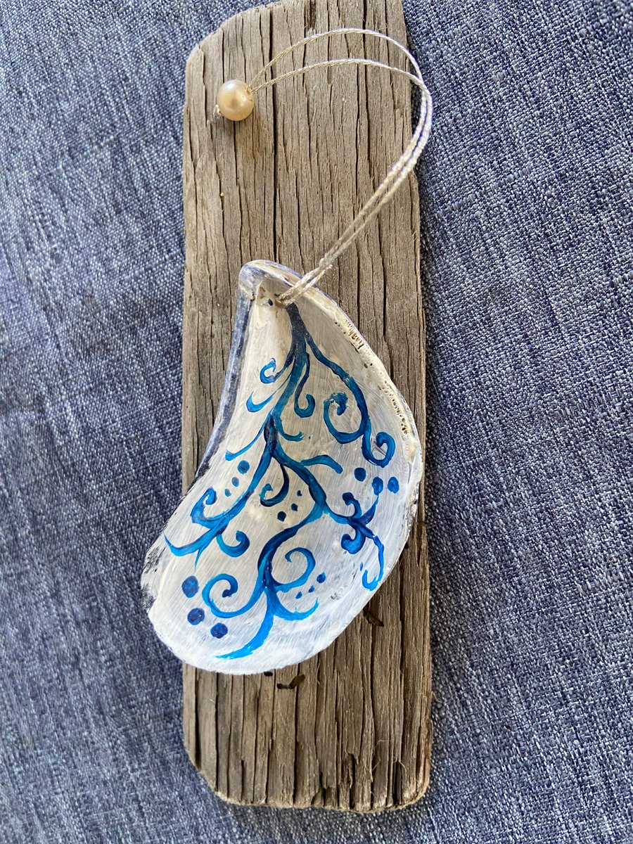 Hand painted mussel shell from an Argyll beach. With a beaded hanger.