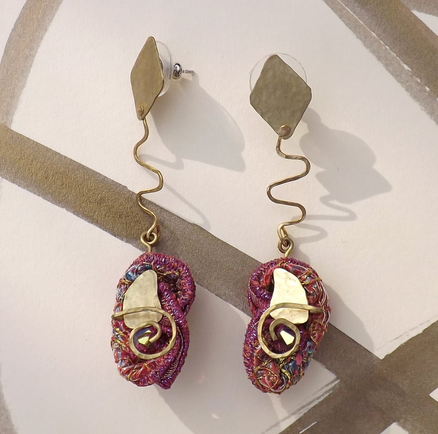 Diamond-drop embroidery and brass earrings.