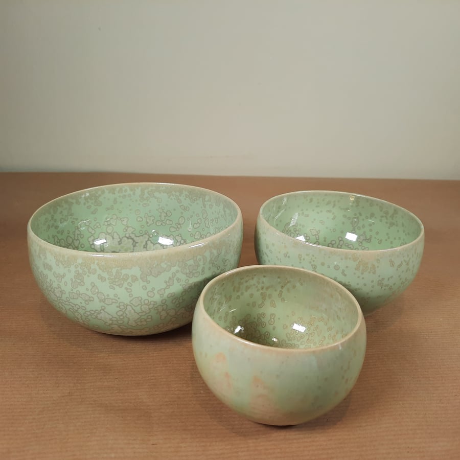 A set of three hand thrown turquoise nesting bowls 
