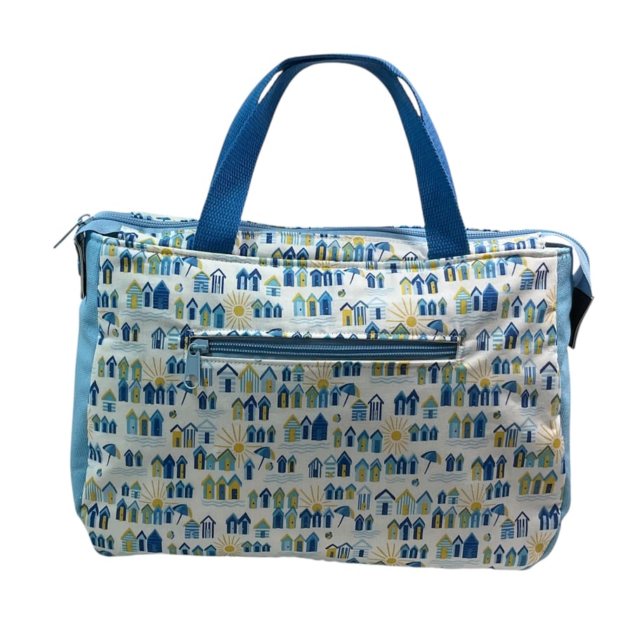 large toiletries bag made from  Liberty fabric, with handles and pockets 