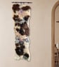 Art felt wall hanging with a large hagstone natural and tactile