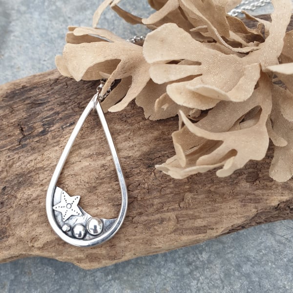 Silver teardrop rockpool beach pendant with starfish