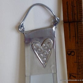 Bathroom mirror decorated with pewter hearts