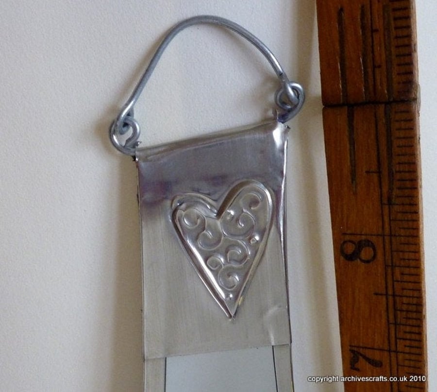 Bathroom mirror decorated with pewter hearts