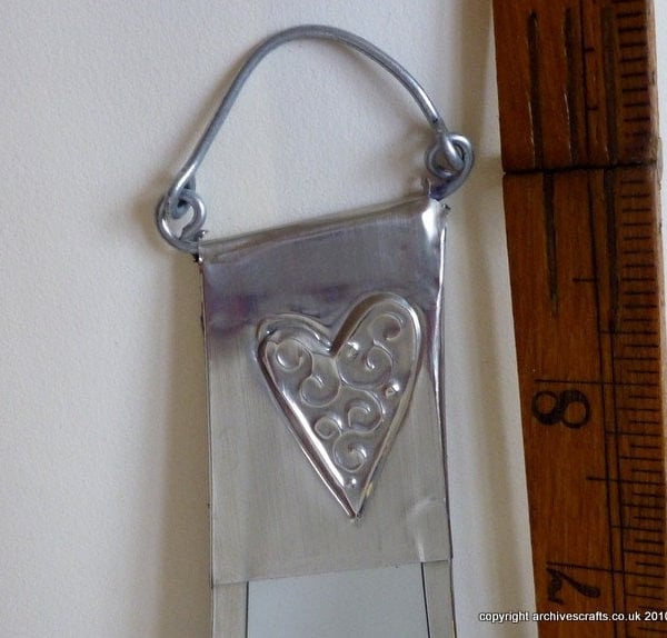 Bathroom mirror decorated with pewter hearts