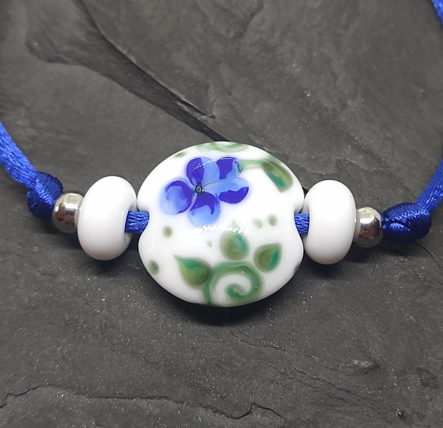 White and blue flower lentil slider bracelet 