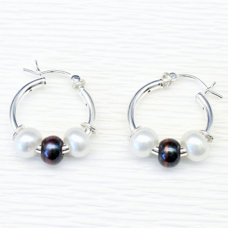 Handmade freshwater pearl earrings featuring white and peacock pearls. 