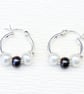 Handmade freshwater pearl earrings featuring white and peacock pearls. 
