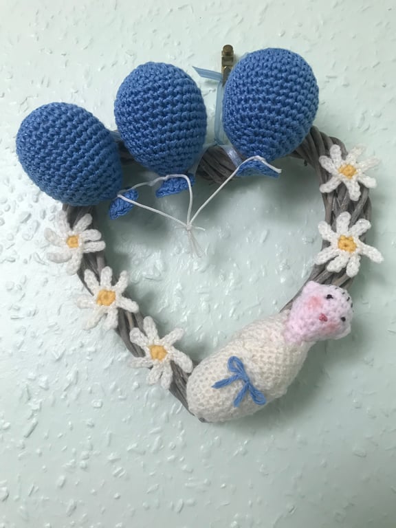 Wicker heart wreath hand decorated with crochet items 