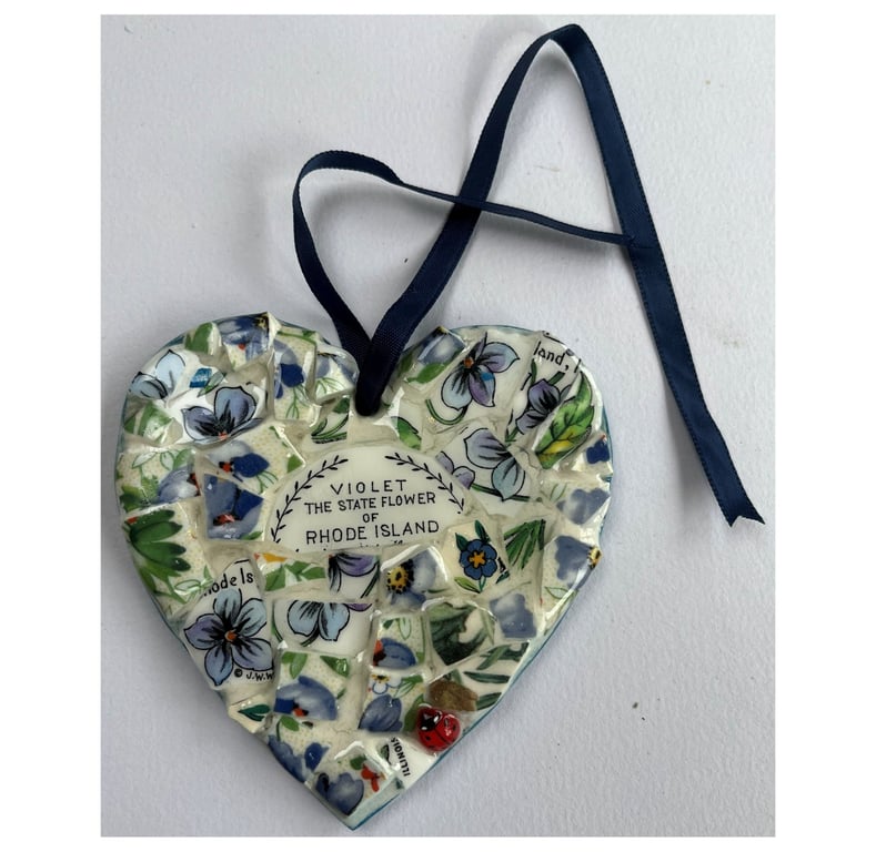 A heart shaped mosaic pendant with violets, the state flower of Rhode Island.