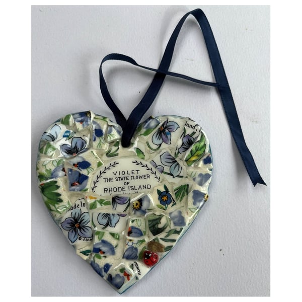 A heart shaped mosaic pendant with violets, the state flower of Rhode Island.