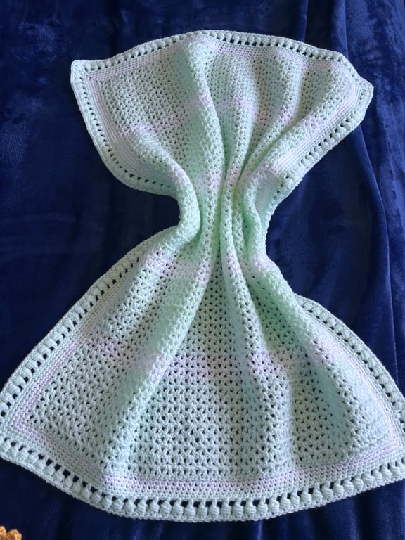 Green and white crocheted baby blanket 