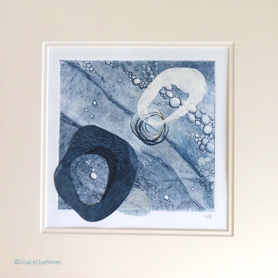 Mixed media abstract of pebbles on the shore in shades of denim blues & white