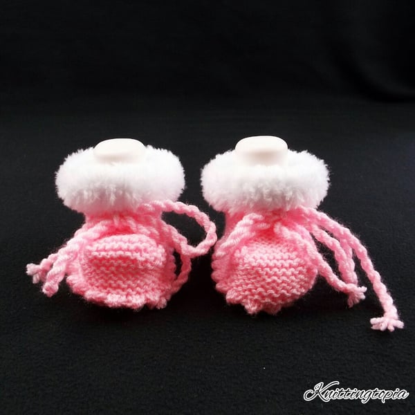 Hand knitted baby pink booties with white faux fur trim 