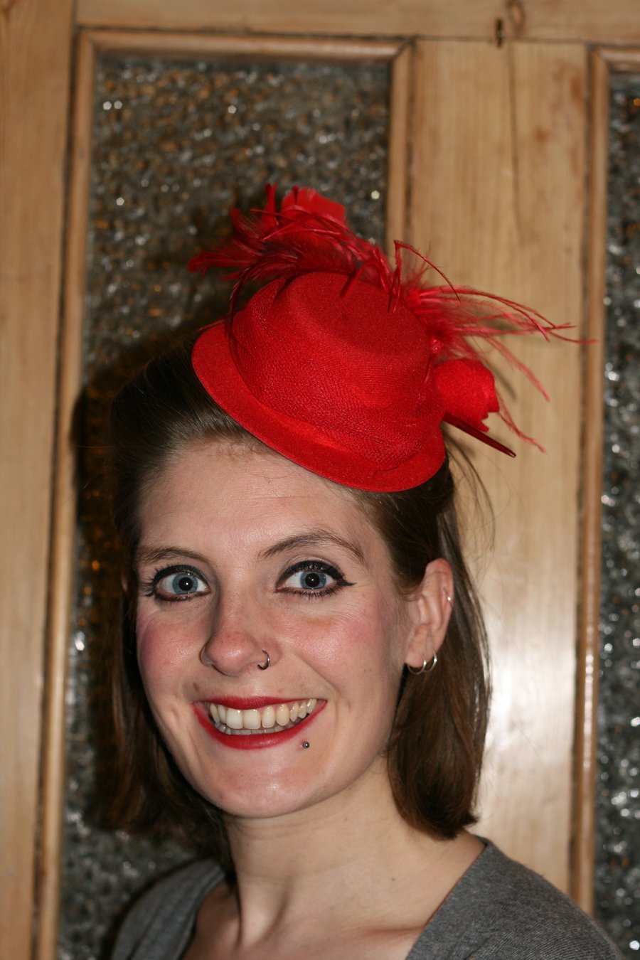 Red mini top hat with feathers and tulle