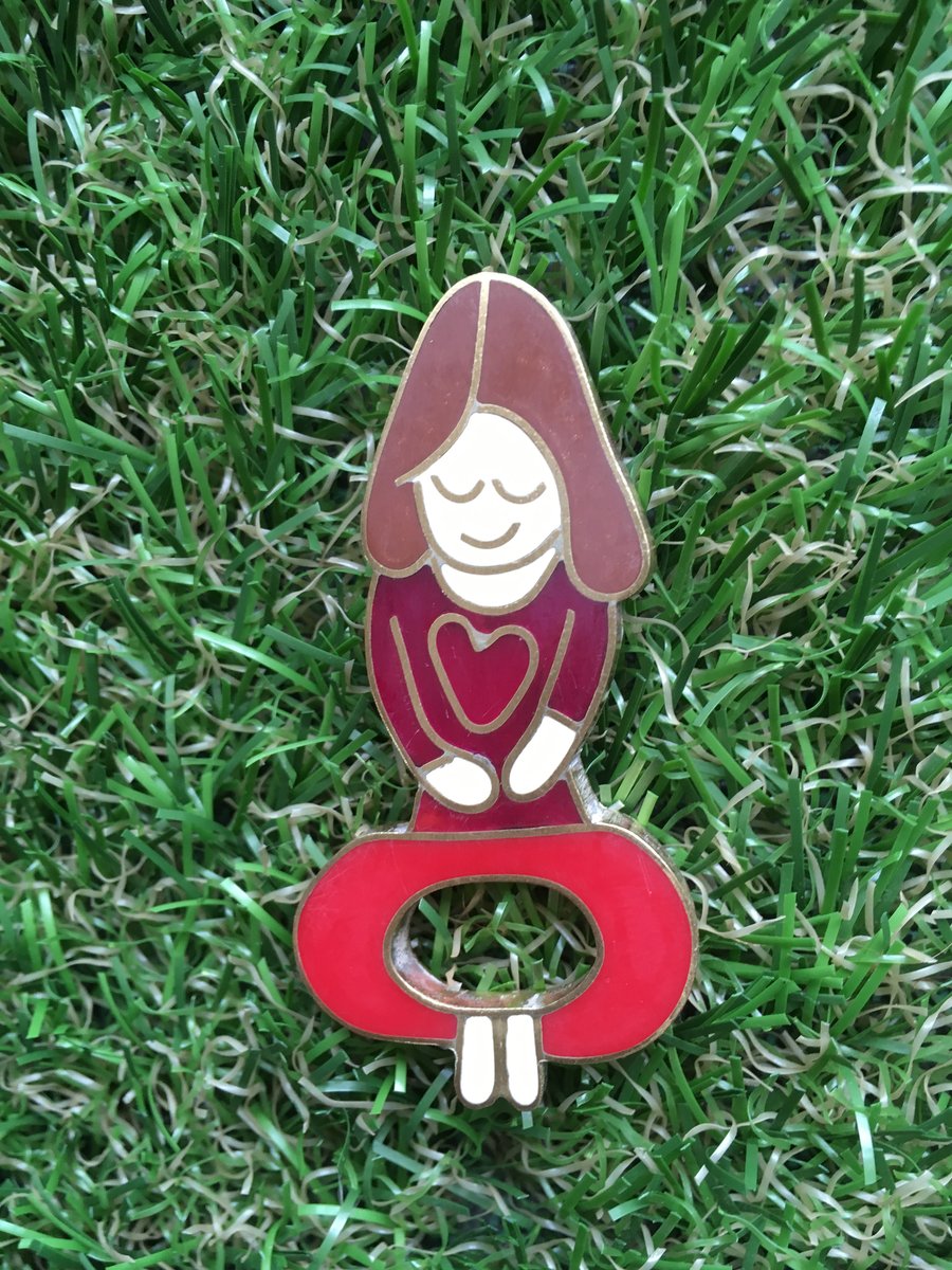 Yoga mummy pin from a childs drawing in resin and metal. 