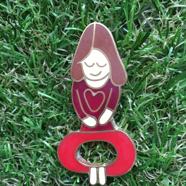 Yoga mummy pin from a childs drawing in resin and metal. 