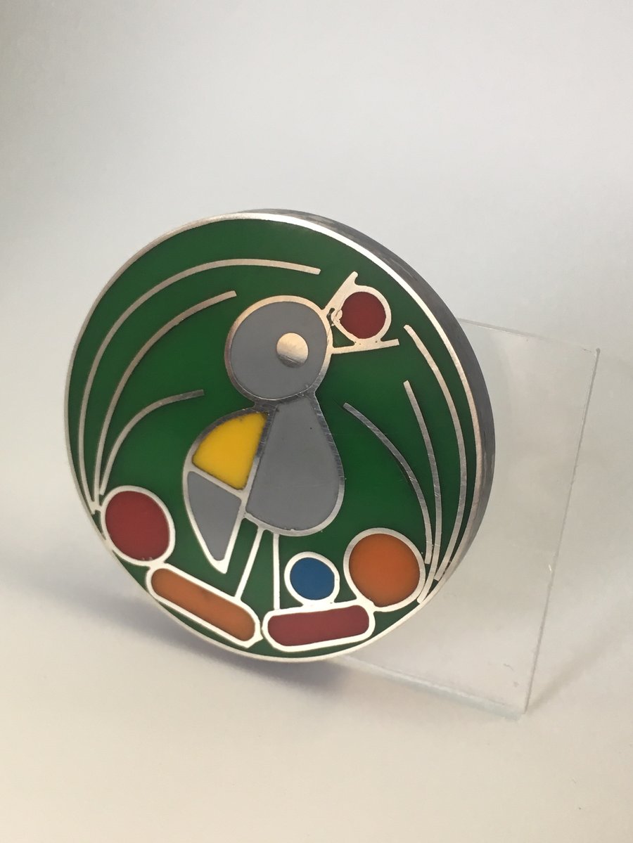 A Bower bird in his nest silver pendant.Handmade in silver with resin.