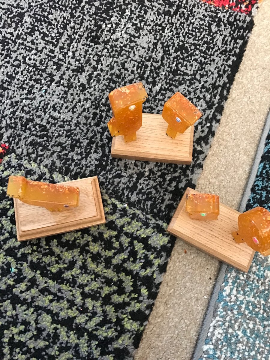 Set of three quirky orange birds on bases in resin